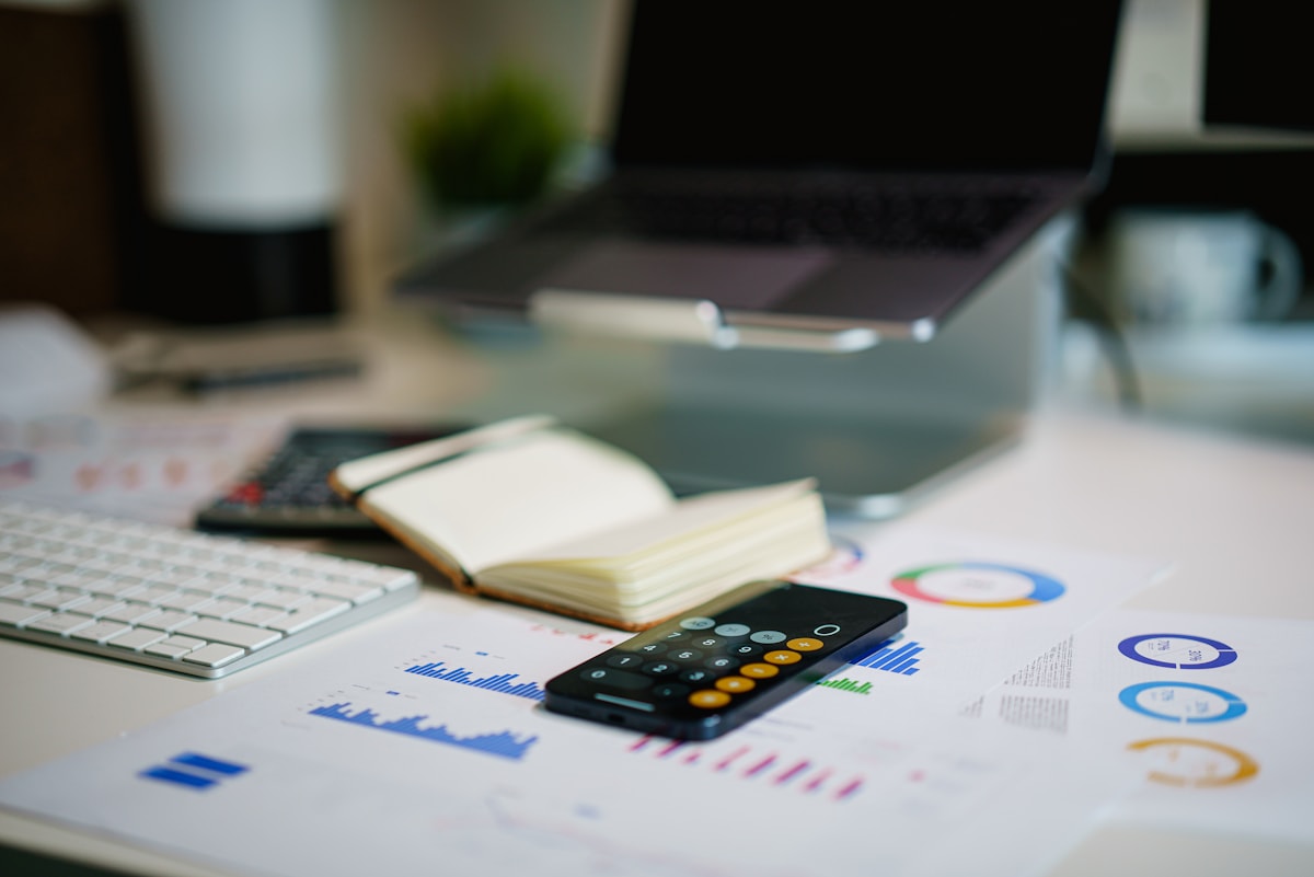 Hands reviewing charts and performance measures at a desk