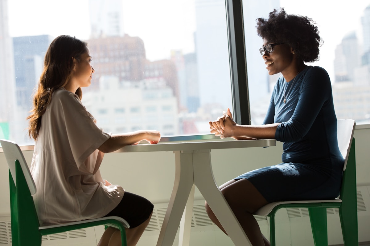 Two technology professionals in a focused conversation